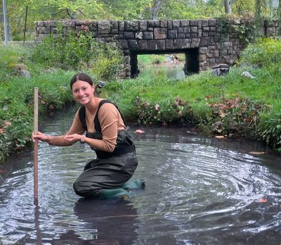 Researcher Andie Flota works in Stroubles Creek 