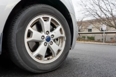 A tire attached to a grey car